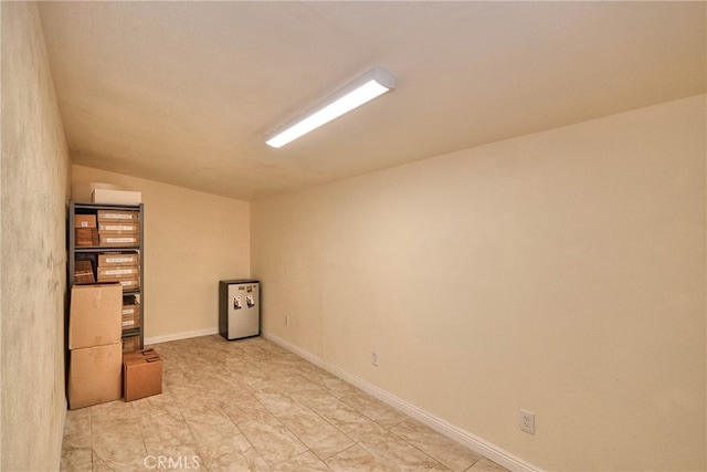 spare room featuring vaulted ceiling