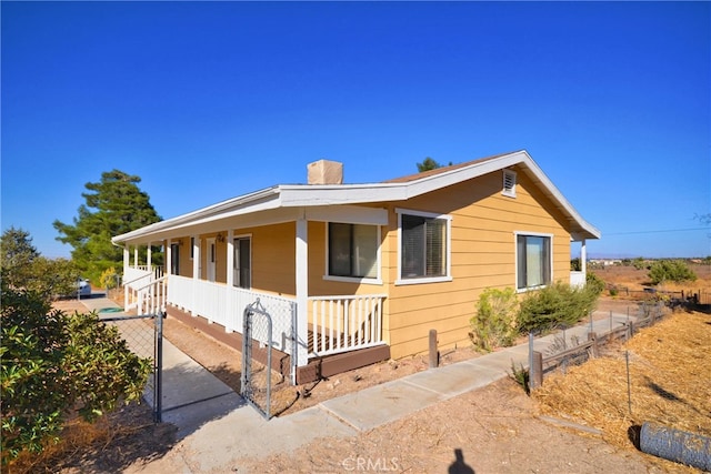 view of side of home with covered porch