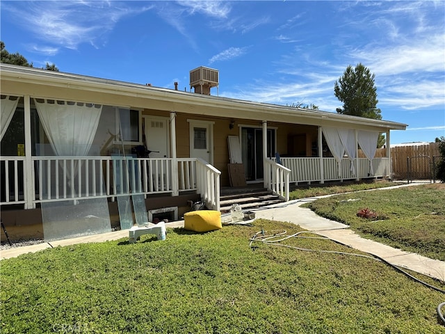 ranch-style house featuring a front yard and a porch