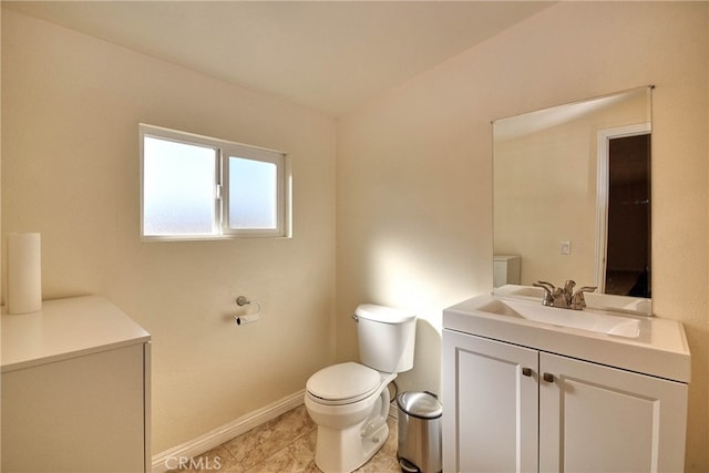 bathroom featuring toilet, vanity, and tile patterned floors