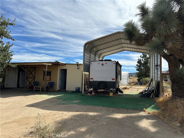 view of vehicle parking featuring a carport