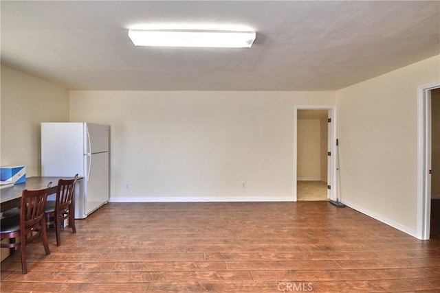 empty room with dark hardwood / wood-style flooring