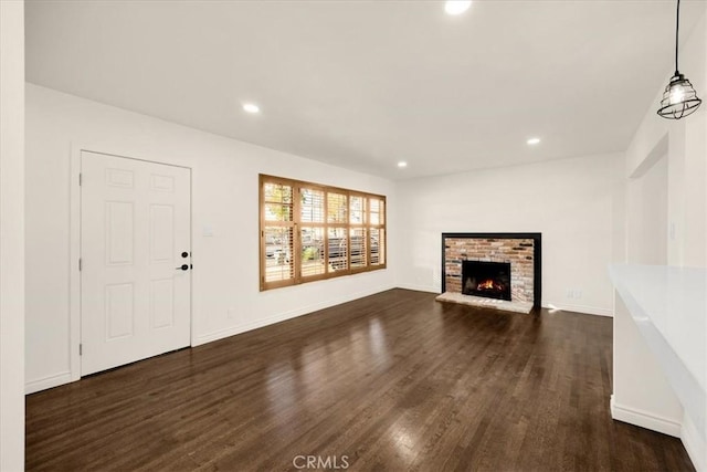 unfurnished living room featuring dark hardwood / wood-style floors and a fireplace