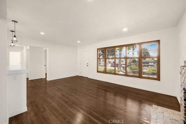 unfurnished living room featuring dark hardwood / wood-style flooring