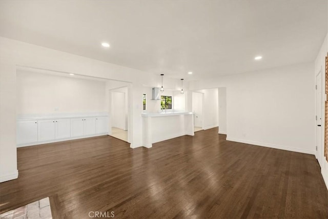 unfurnished living room featuring dark hardwood / wood-style floors