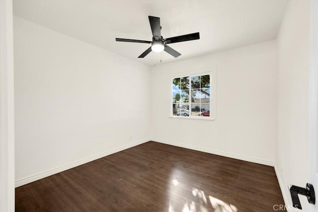 spare room featuring ceiling fan and dark hardwood / wood-style flooring