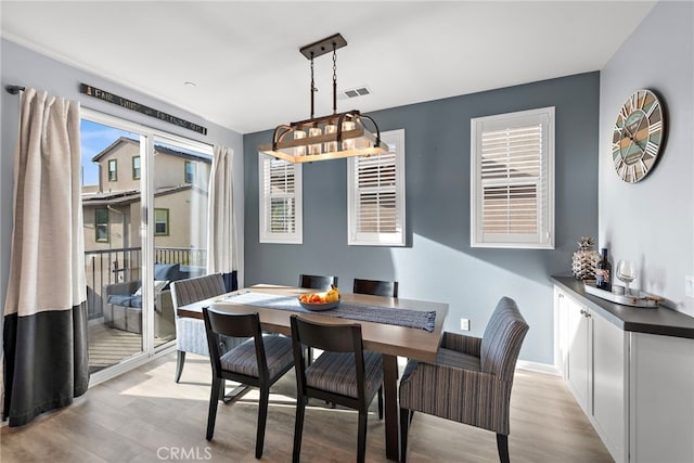 dining space with light hardwood / wood-style flooring