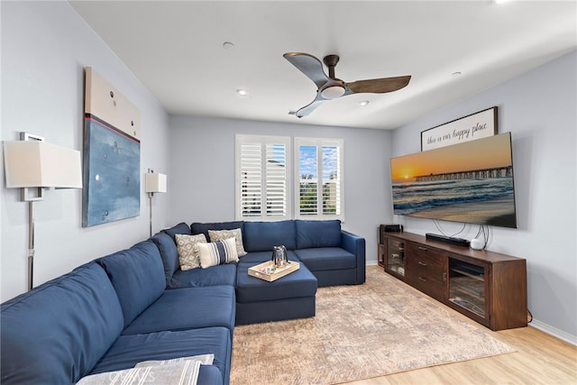 living room featuring ceiling fan and light hardwood / wood-style flooring