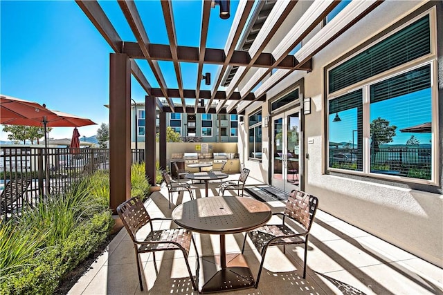 view of patio / terrace featuring a pergola and an outdoor kitchen