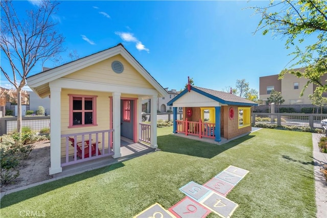 exterior space featuring a front yard and an outbuilding