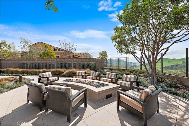 view of patio featuring an outdoor living space with a fire pit