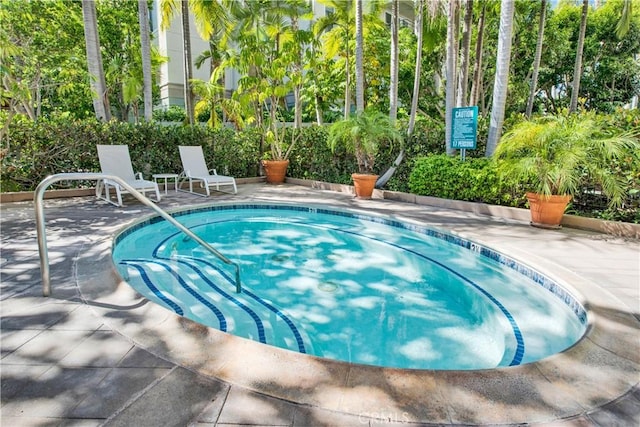 view of pool featuring a patio area and a community hot tub