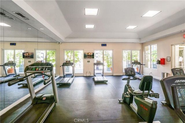 workout area featuring a tray ceiling