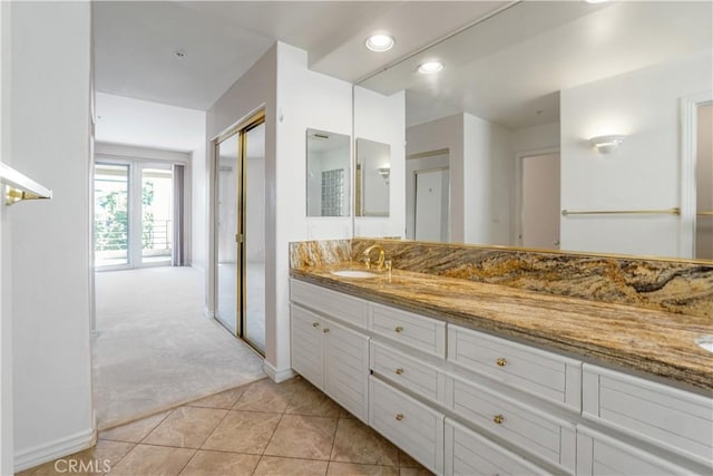 bathroom featuring tile patterned floors, vanity, and french doors