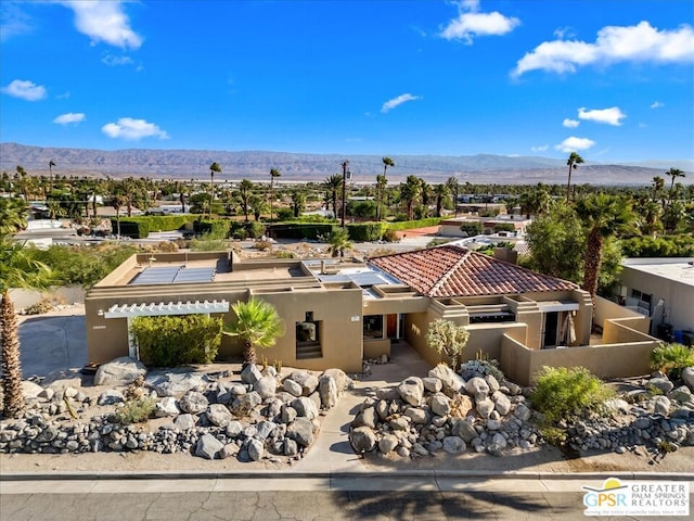 birds eye view of property with a mountain view