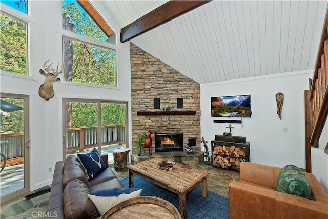 living room with beam ceiling, plenty of natural light, a fireplace, and high vaulted ceiling