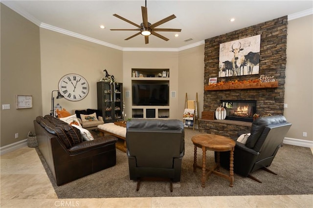 tiled living room with ceiling fan, built in features, a stone fireplace, and ornamental molding