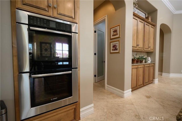 kitchen featuring crown molding and stainless steel double oven