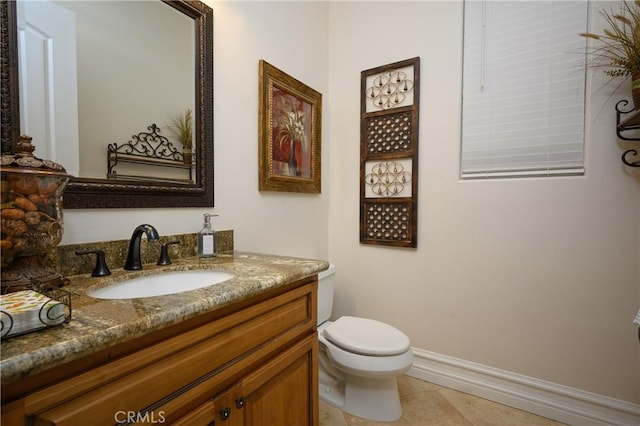 bathroom with tile patterned flooring, vanity, and toilet