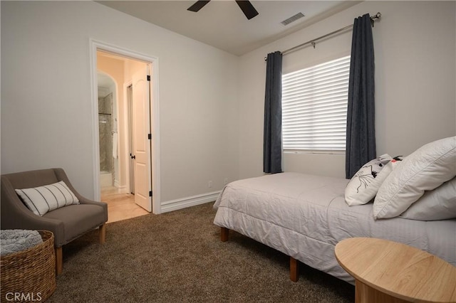 carpeted bedroom featuring ceiling fan and ensuite bath