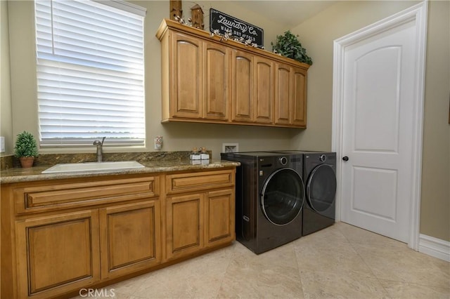 clothes washing area with washer and clothes dryer, sink, light tile patterned floors, and cabinets