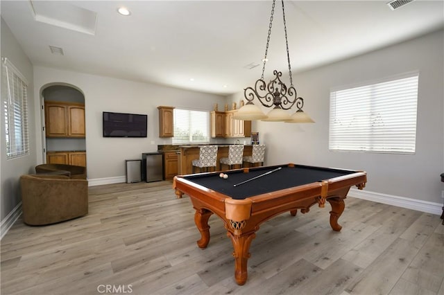 rec room featuring light wood-type flooring, a wealth of natural light, and pool table