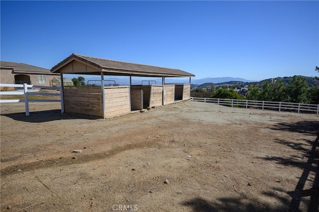 view of stable featuring a mountain view