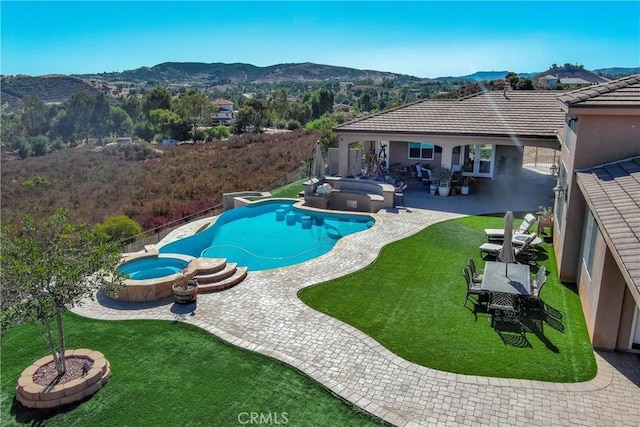 view of swimming pool featuring outdoor lounge area, grilling area, a mountain view, an in ground hot tub, and a patio