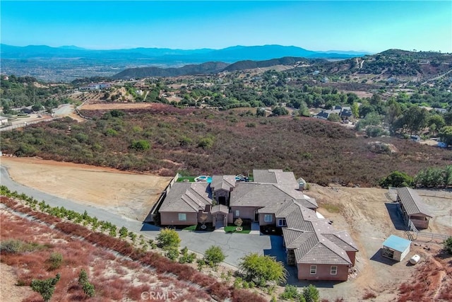 birds eye view of property featuring a mountain view