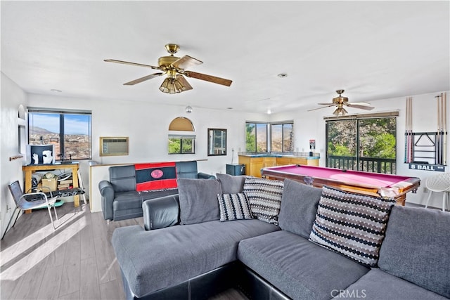 living room with light hardwood / wood-style floors, billiards, plenty of natural light, and ceiling fan