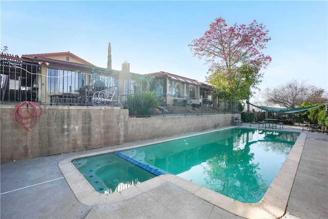 view of swimming pool featuring a patio and an in ground hot tub