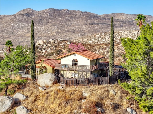 rear view of house featuring a mountain view