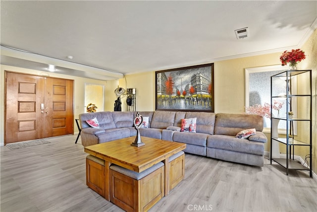 living room with crown molding and light hardwood / wood-style flooring