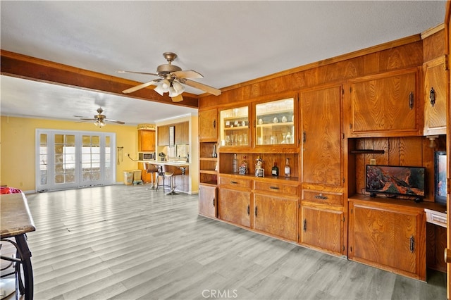 kitchen featuring french doors, a textured ceiling, light wood-type flooring, and ceiling fan