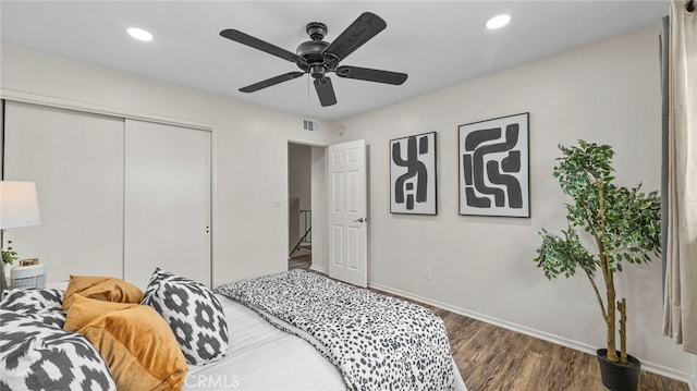 bedroom featuring dark hardwood / wood-style flooring, a closet, and ceiling fan