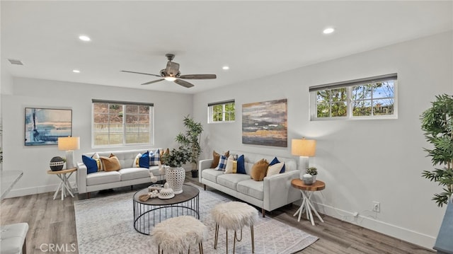 living room featuring ceiling fan and wood-type flooring