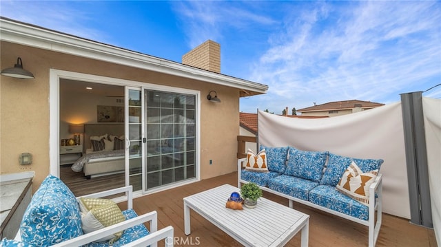 wooden balcony with an outdoor living space and a deck