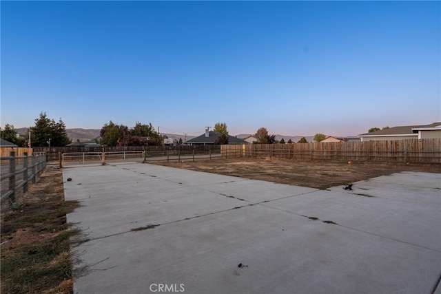 patio terrace at dusk featuring a mountain view