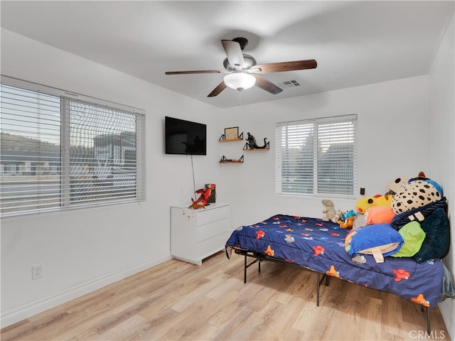 bedroom with light wood-type flooring and ceiling fan