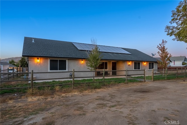 view of front of property with solar panels