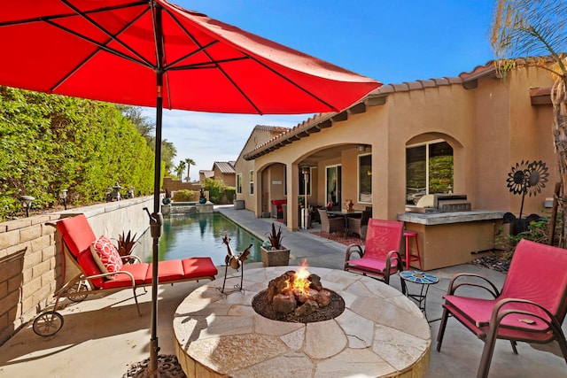 view of patio with a fire pit