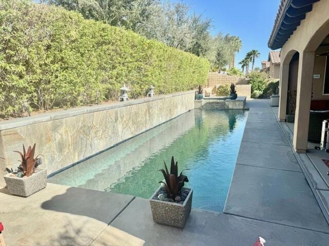 view of pool featuring a patio