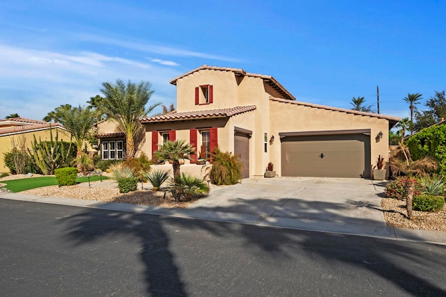 mediterranean / spanish home with a garage