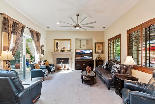 carpeted living room with ceiling fan