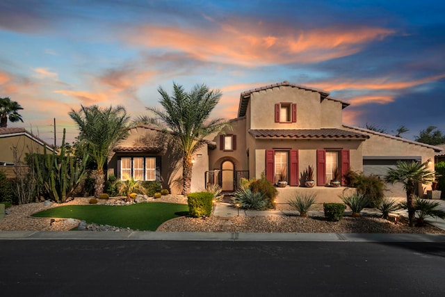 mediterranean / spanish house featuring a garage