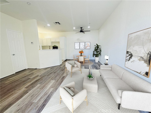 living room with ceiling fan and hardwood / wood-style flooring