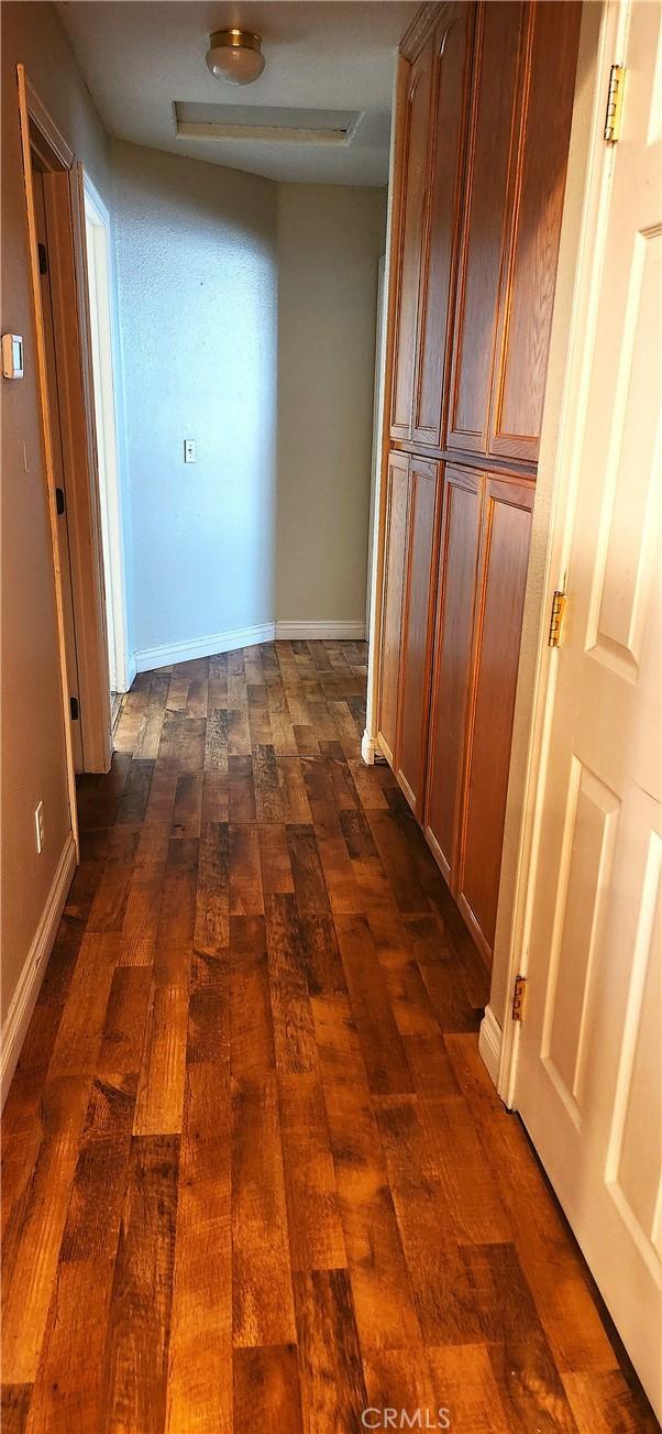 corridor with dark wood-type flooring