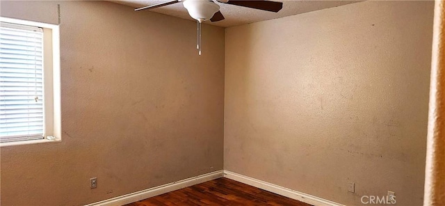 empty room featuring ceiling fan and dark wood-type flooring