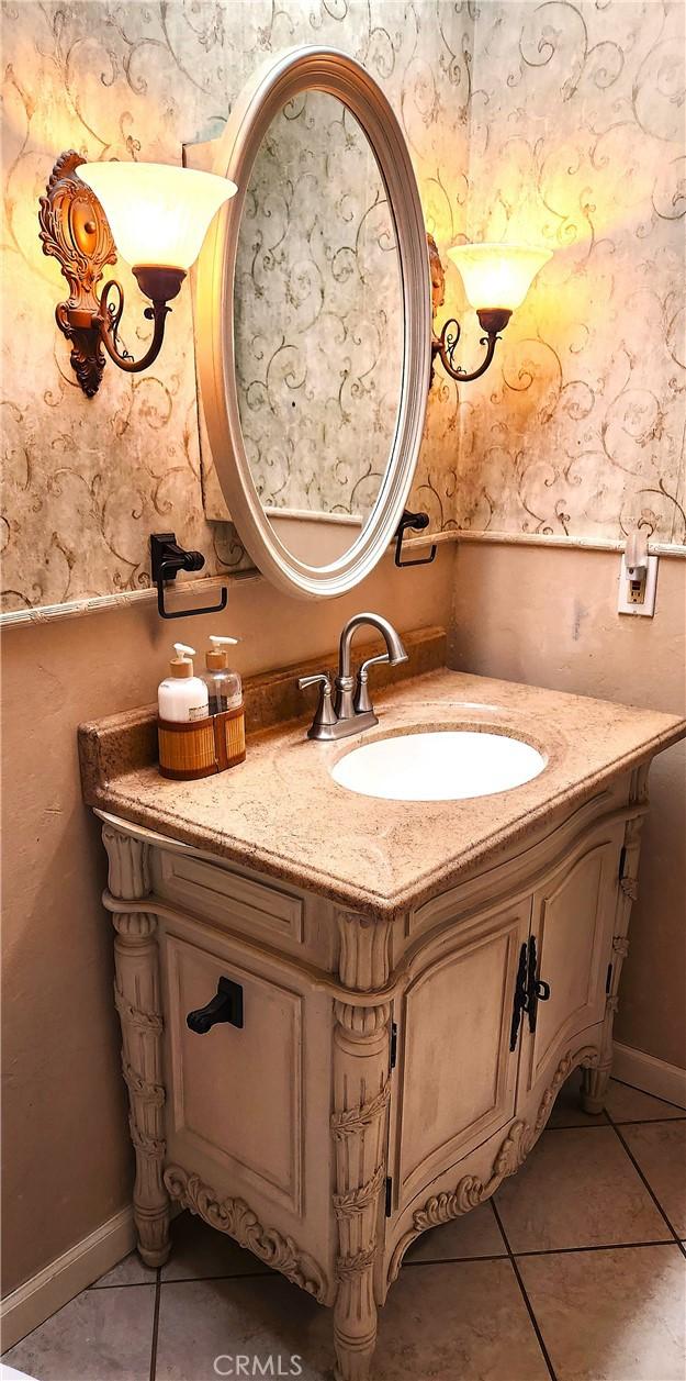 bathroom with tile patterned flooring and vanity