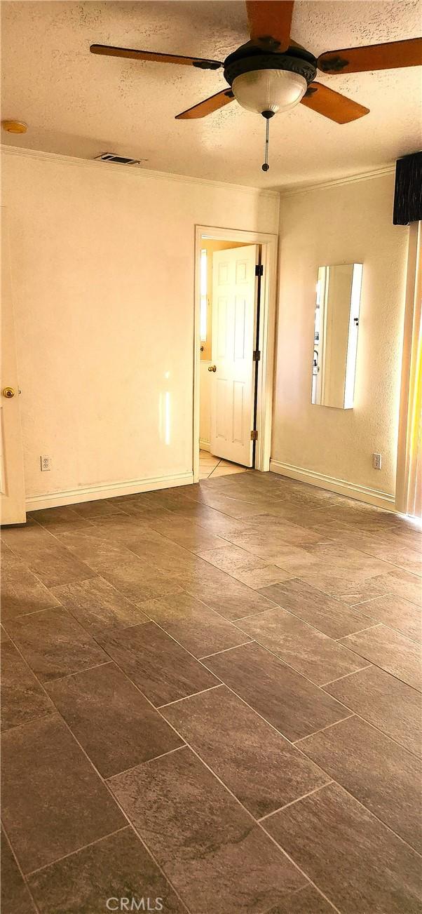 unfurnished room with a textured ceiling